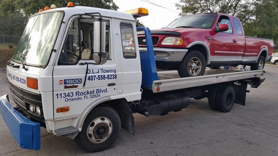 DLJ tow truck carrying a Ford F-150 pickup